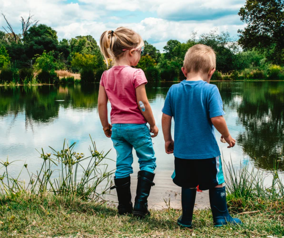 Two children by a lake